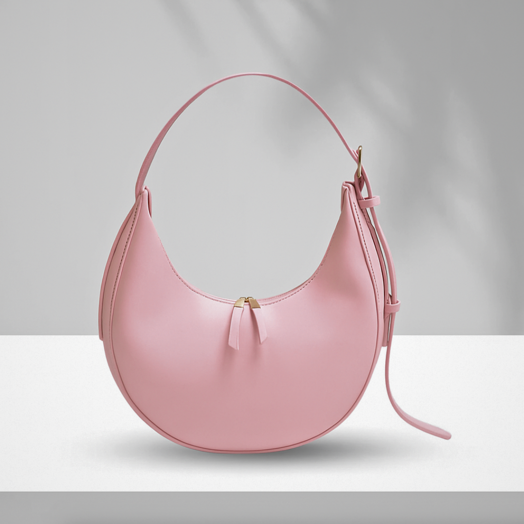 Pink U-shaped hobo bag with single zipper compartment and adjustable shoulder strap, sleek and modern synthetic leather design.